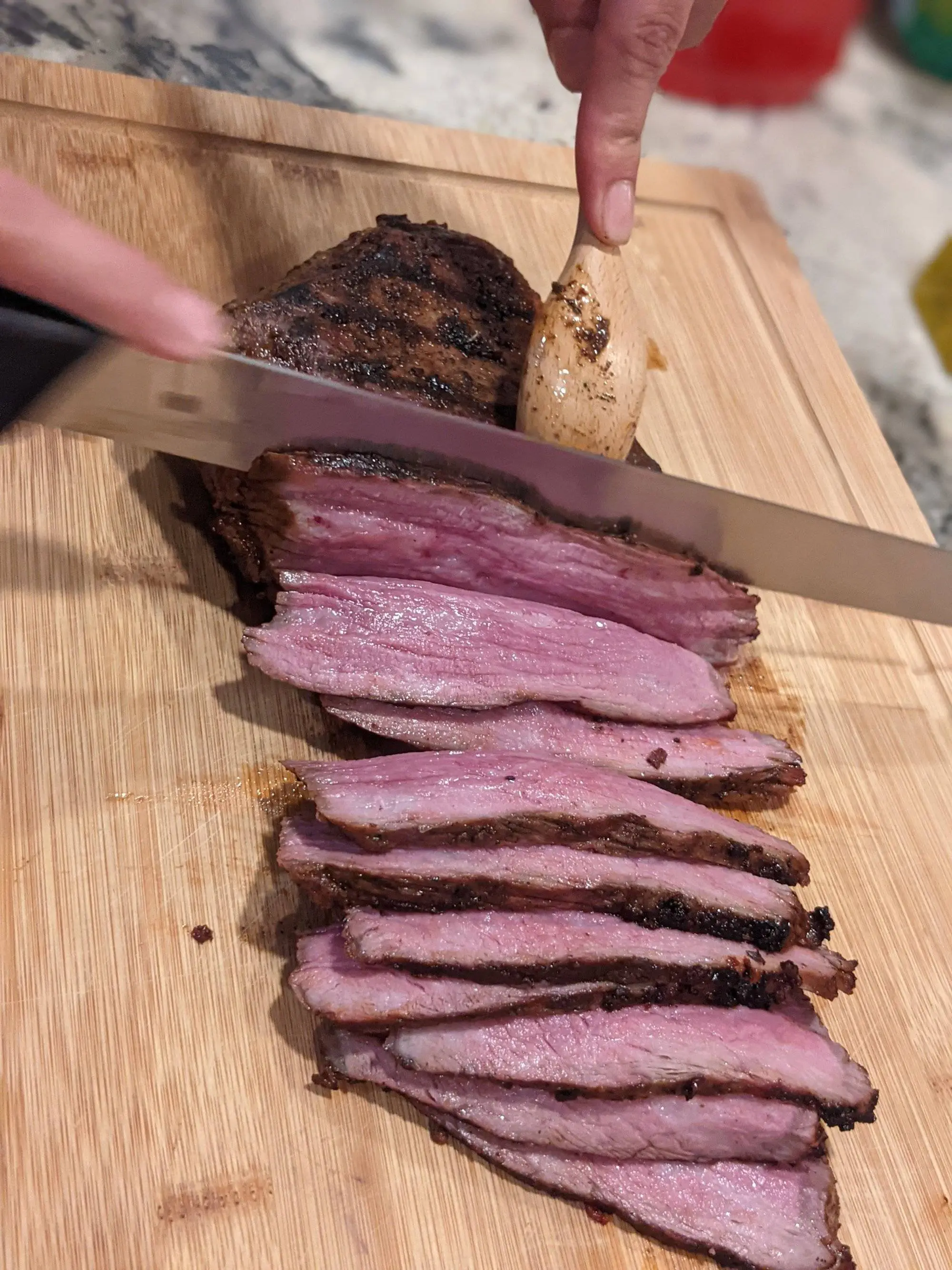 Freshly grilled Tri-tip being cut into thin slices.