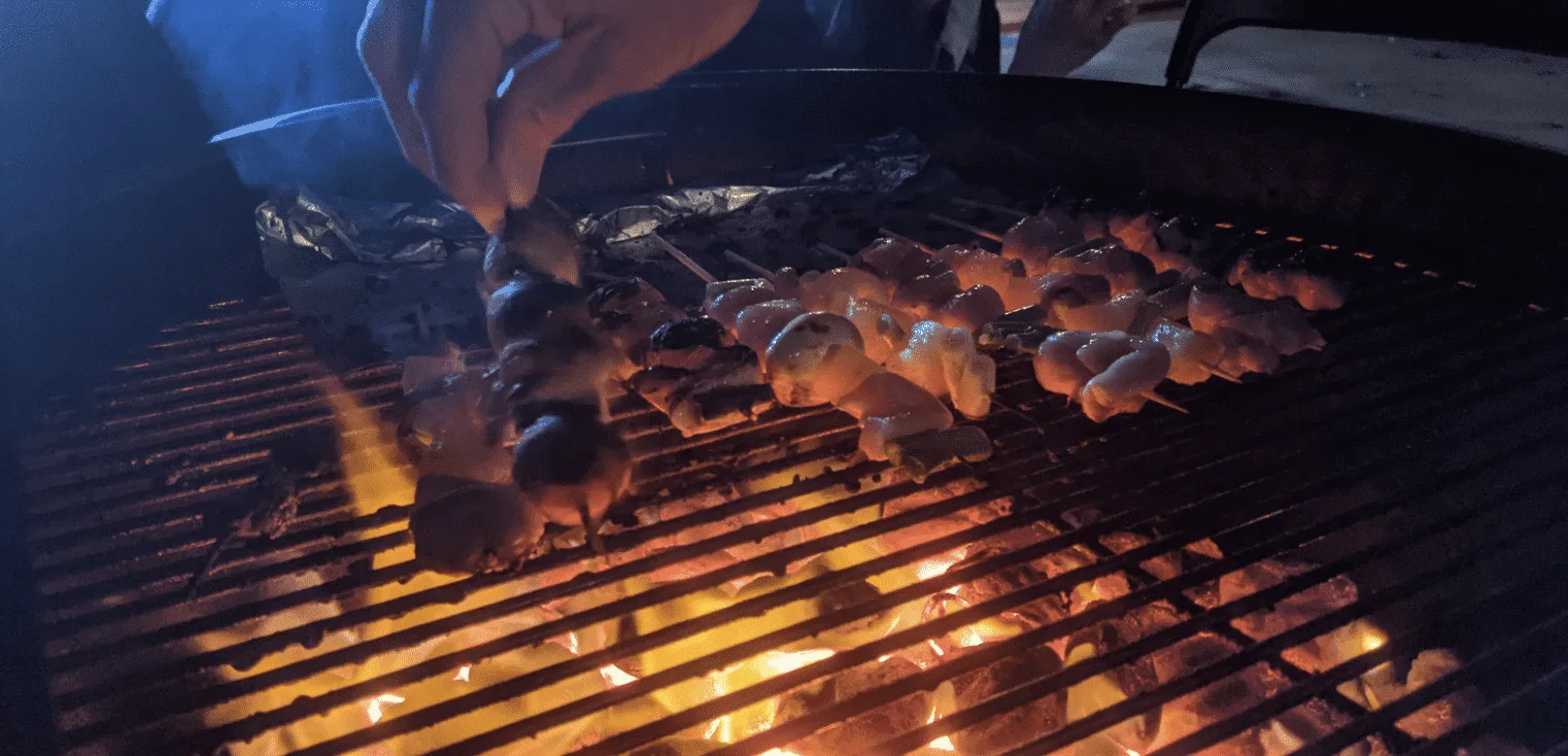 Side view of delicious chicken Skewers on a Charcoal Grill