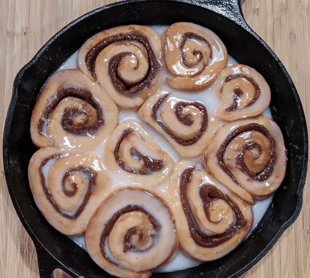 Top View of Homemade cCnnamon Rolls in a cast iron pan.