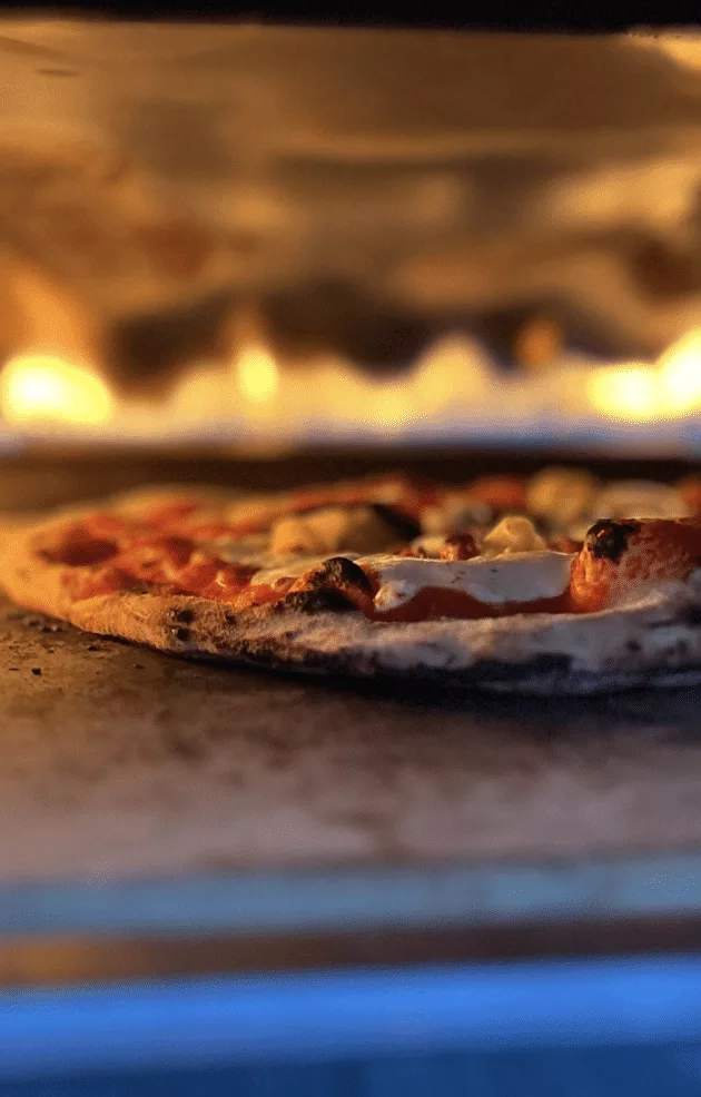 Close up of homemade Pizza in an Ooni Pizza Oven.