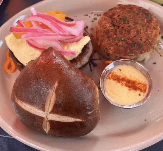 Side view of a pretzel bun breakfast sandwich.
